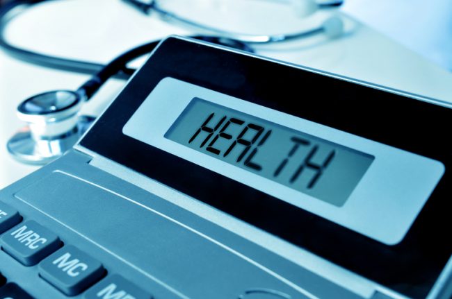 stethoscope and word health in the display of a calculator